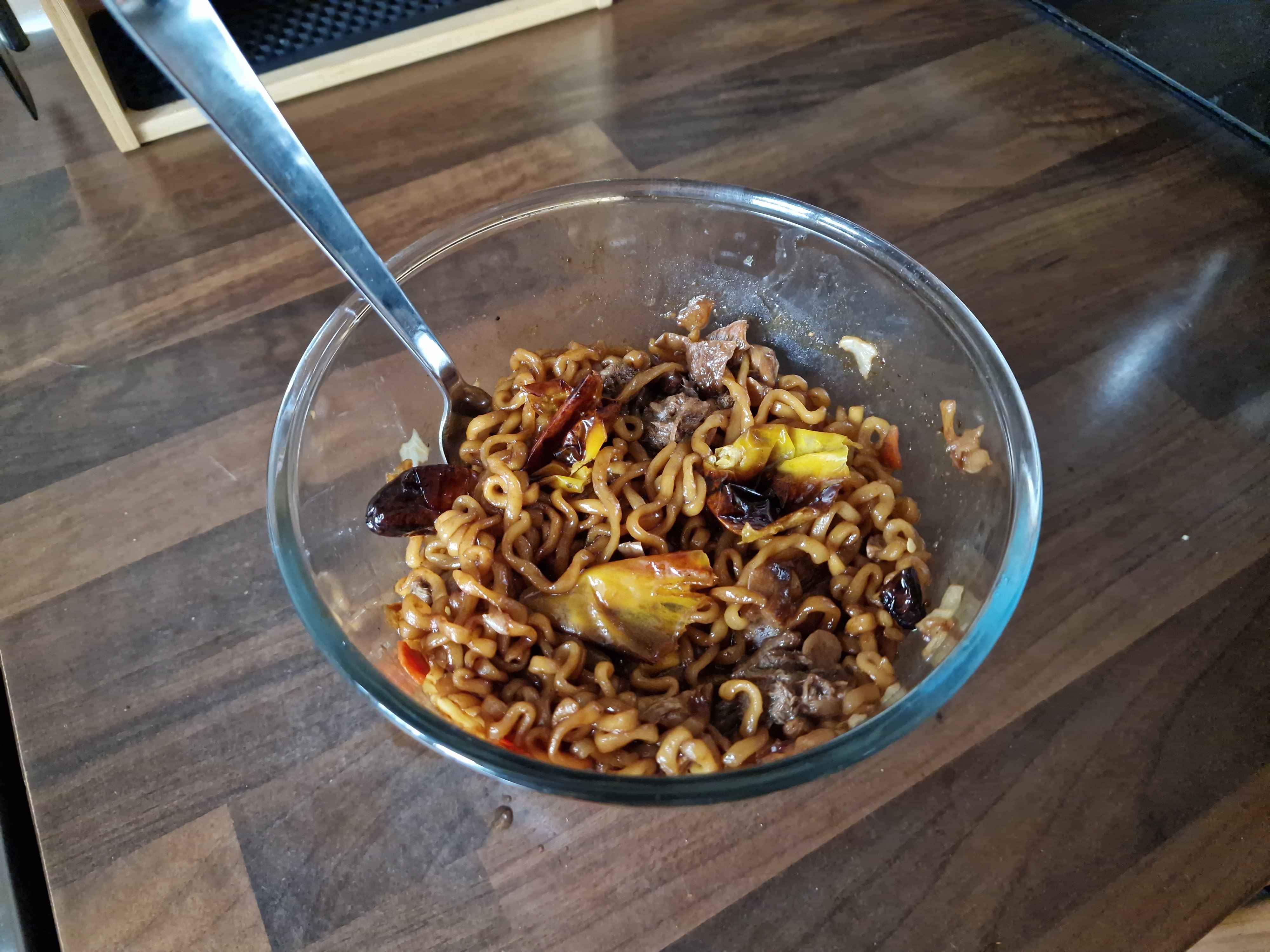 The finished bowl of noodles, as prepared with added mushrooms and roasted peppers.
