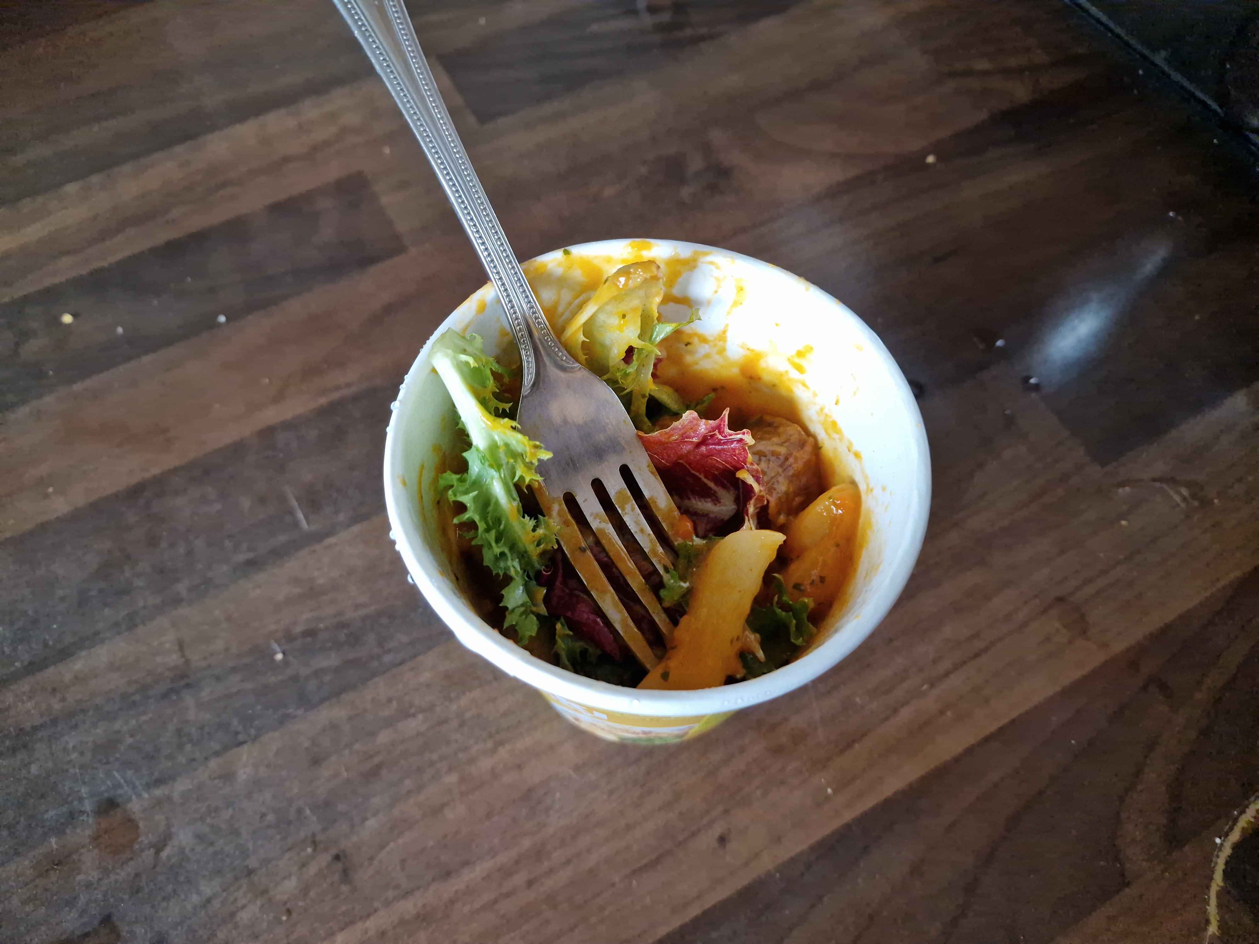 Prepared cup of rice cakes with sausage and salad