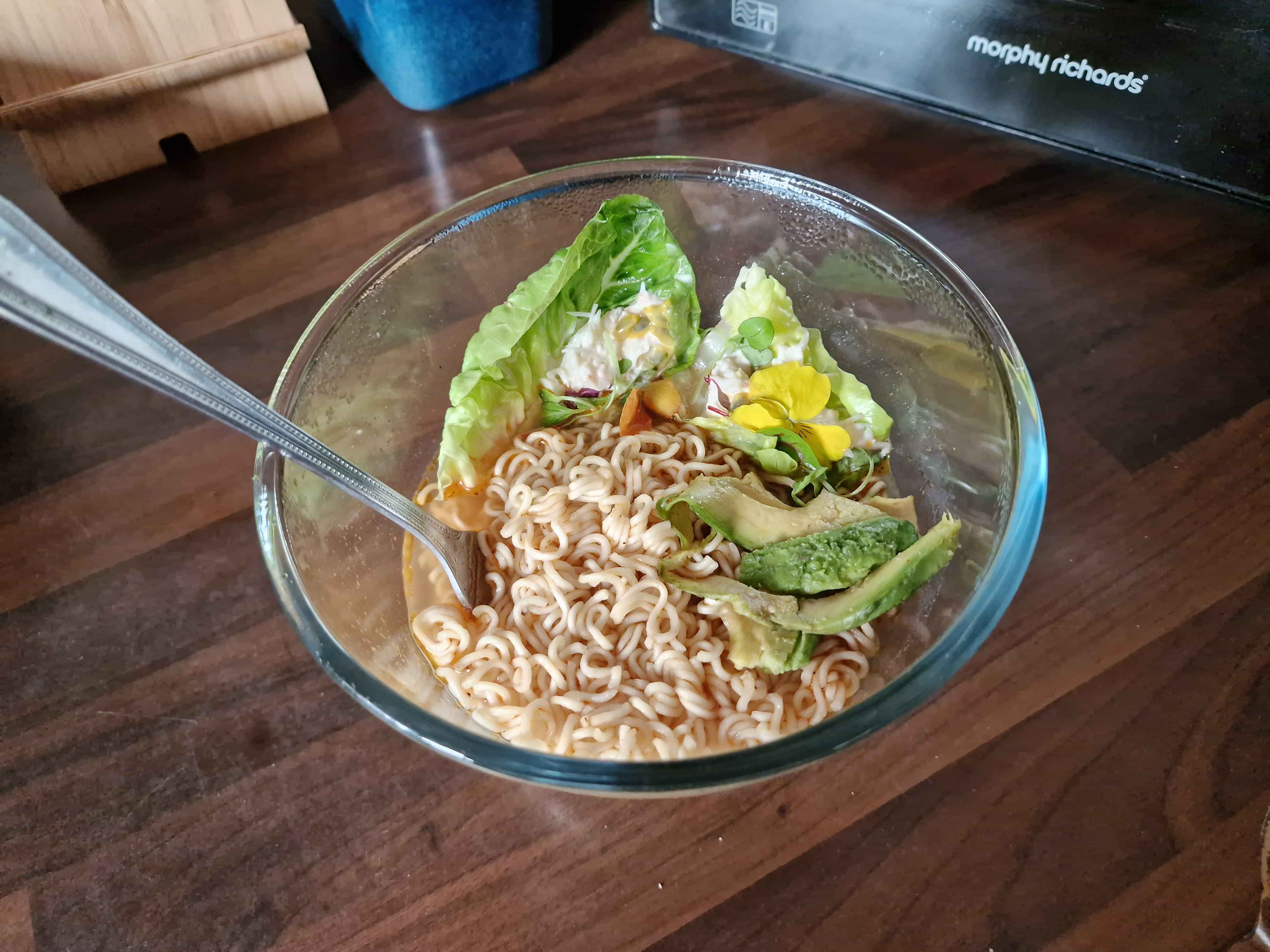 The finished ramen bowl with added crab meat, lettuce and avocado.