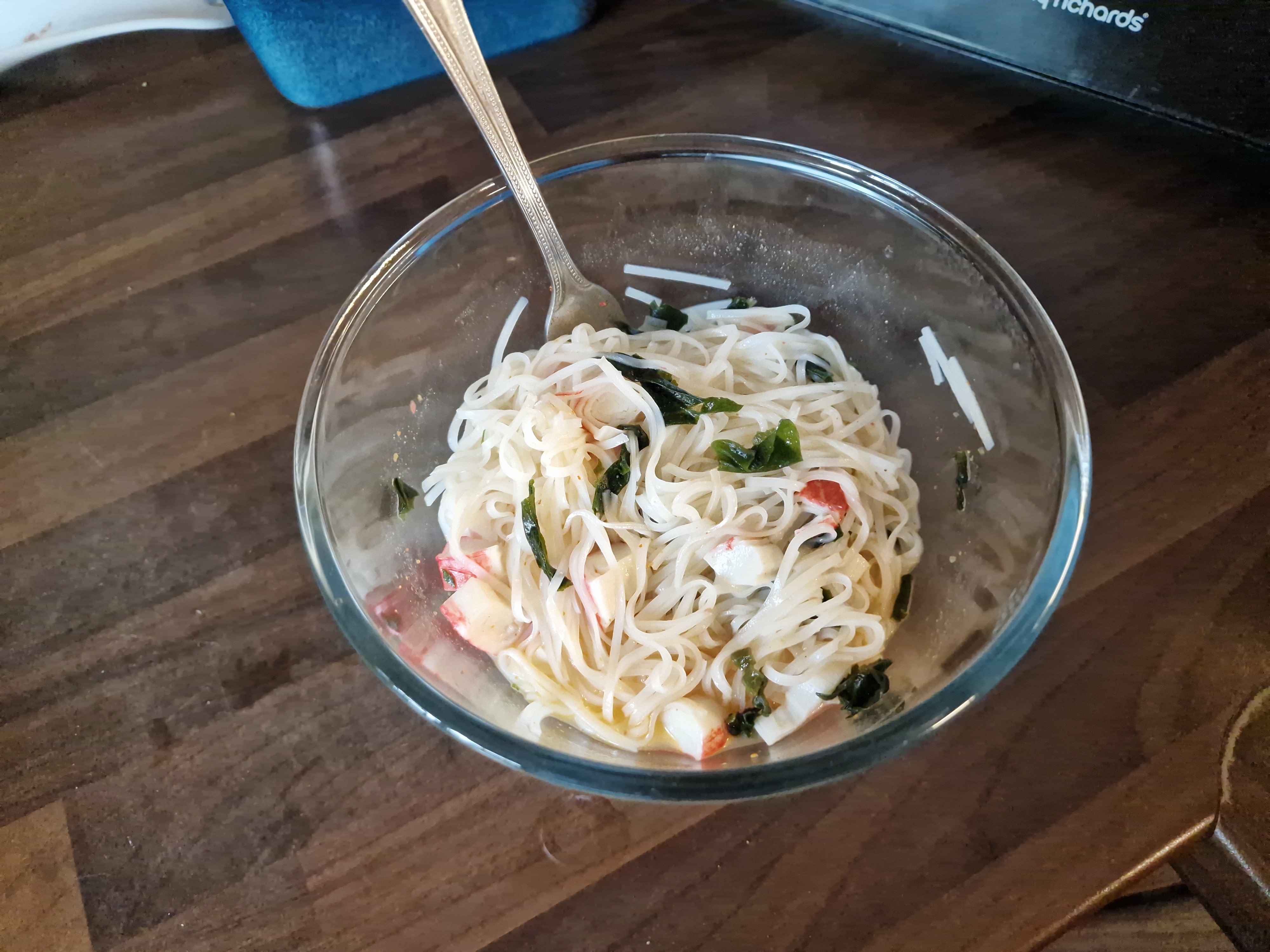The same bowl as before, with the noodles prepared and with seafood sticks and seaweed added.